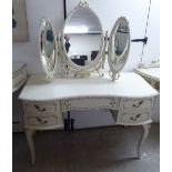 A modern French inspired white painted and gilded five drawer kneehole dressing table,