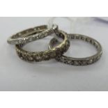 A 9ct white gold and two silver coloured metal eternity rings,
