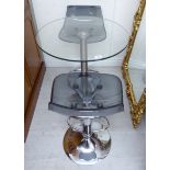 A modern glass pedestal table,