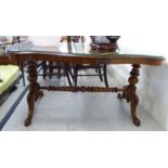 A modern mahogany coffee table with a serpentine outlined edge raised on splayed legs 20''h 41''w