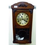A 1920s oak cased wall clock;
