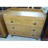 A mid 20thC light oak three drawer dressing chest,