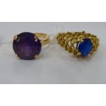 Two yellow metal rings, one set with a blue stone,