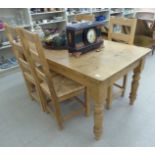 A modern pine farmhouse kitchen table with an end drawer, raised on turned,