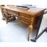A modern Louis XV inspired mahogany finished kneehole desk with five graduated drawers,