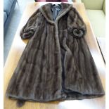A Grosvenor at Harrods brown mink, knee length coat with detailed sleeves and a belt approx.