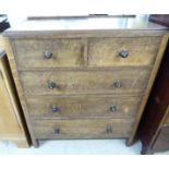 A 1930s oak five drawer dressing chest,