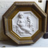 A modern composition marble effect plaque of octagonal form, depicting a mother and child,
