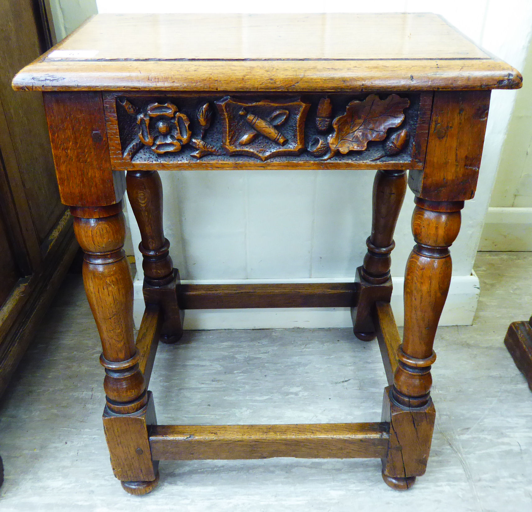 An Edwardian Jacobean design oak joint stool, the frieze carved with a date '1904' raised on turned,