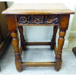 An Edwardian Jacobean design oak joint stool, the frieze carved with a date '1904' raised on turned,