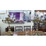 A pair of modern lacquered brass ten branch candelabra, each set on a tapered and baluster column,