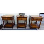 A set of three Ercol light coloured elm lamp tables, each with a frieze drawer,