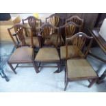 A set of seven George III stained ash framed chairs with pierced vase splats and fabric covered