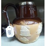 A Royal Doulton two tone brown glazed stoneware harvest jug with an applied silver rim HW