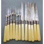 A set of six Edwardian cake knives and forks with silver blades,