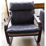 A modern 'retro' design teak framed easy chair with stitched black hide back and seat,