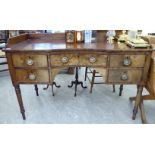 An early/mid 19thC mahogany kneehole writing desk with a low galleried upstand,