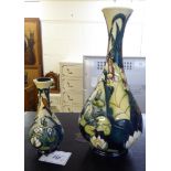 Two similar modern Moorcroft pottery bottle vases of bulbous form, having long,