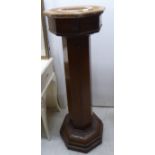 An early/mid 20thC oak pedestal of octagonal form,