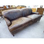 A modern four person settee, upholstered in two tone brown hide,