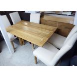 A modern light oak metamorphic dining table, raised on block legs 30''h 52''L 20''w (closed),