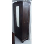 An Art Nouveau period string inlaid oak wardrobe with a single moulded door,