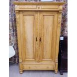 An early 20thC French inspired rustically constructed, bleached pine two door wardrobe,