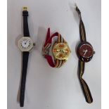Two modern plastic/faux mother-of-pearl cased wristwatches; and another in yellow metal,