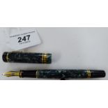 A Parker (cartridge type) fountain pen, in a marbleised green, black and yellow metal mounted case,