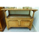A 1930s oak monks' bench with a hinged top, over a box seat,