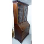 An early 19thC string inlaid mahogany bureau bookcase, the superstructure with a moulded cornice,