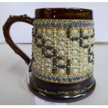A Doulton Lambeth brown, green, blue and cream coloured glazed mug of tapered form,