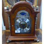 A modern Georgian inspired figured walnut cased bracket clock with gilded brass mounts,