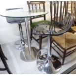 A modern glass pedestal table,