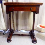 A late Victorian flame mahogany work table with a rotating foldover top, over a frieze drawer,