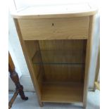 A modern light oak framed side table with a mirrored top, side panels and two glazed shelves,