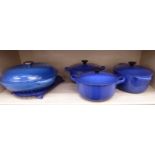 Le Creuset enamelled blue cast iron covered tableware comprising a pair of circular casseroles,