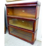 A mid 20thC stained beech three section Globe Wernicke bookcase with two rise-and-slide glazed