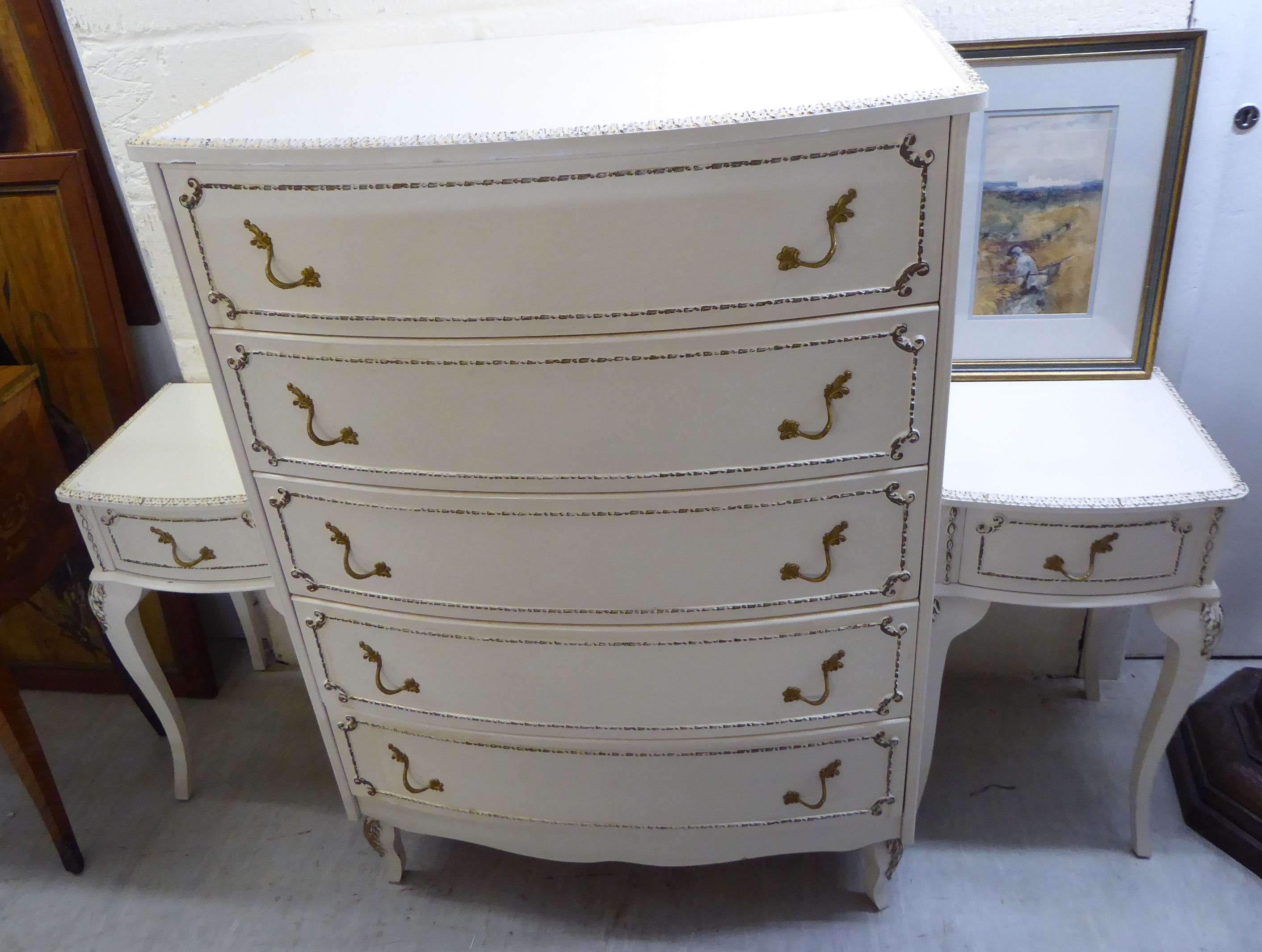 A modern French inspired cream coloured painted and gilded five drawer dressing chest,