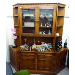 An Ercol light coloured elm living room unit, comprising two central glazed drawers,