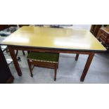 A mid 20thC kitchen table, the yellow formica top with rounded corners and a single frieze drawer,
