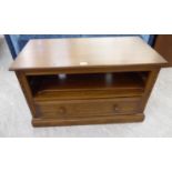 An Ercol light coloured elm television/video cabinet with a base drawer,