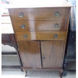 A 1930s mahogany music cabinet with three drawers over a pair of doors,