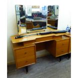 A G-Plan light oak dressing table, surmounted by a triptych mirror,