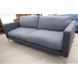 A Conran three person settee with a level back and embroidered arms,