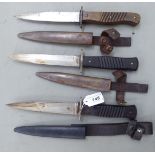 Three similar military trench knives with ribbed wooden handles, the blades 6.