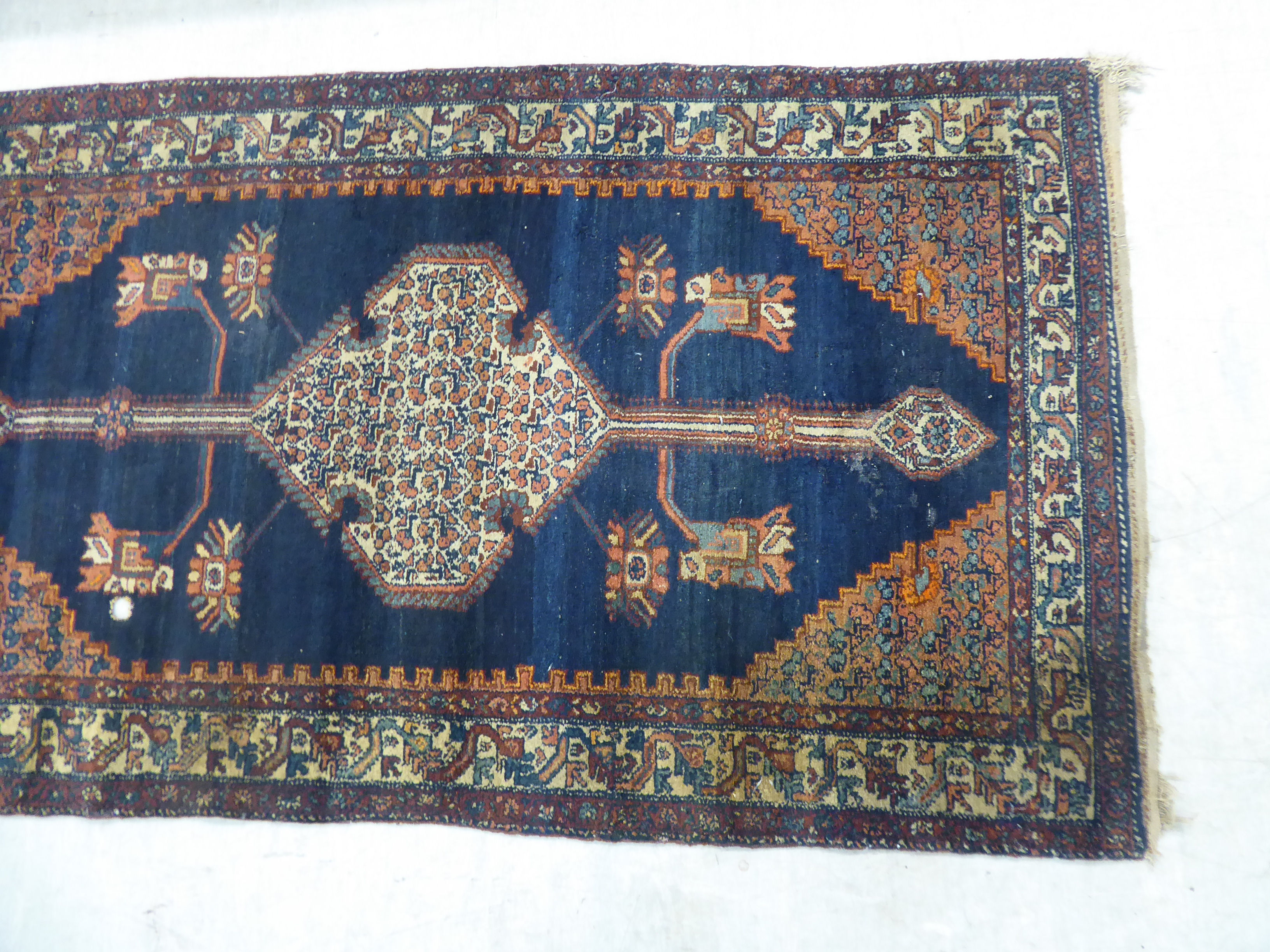 A Persian rug, decorated with a central medallion and four corners of stylised designs, - Image 2 of 4