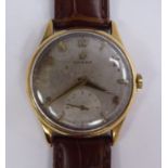 A 1957 Omega 9ct gold cased wristwatch, faced by an Arabic and baton dial and a subsidiary,