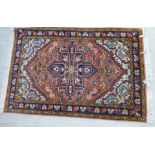 A Persian rug, decorated with stylised designs,