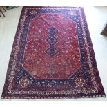 A Persian carpet, profusely decorated with stylised designs,